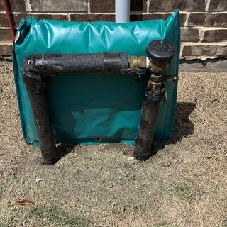 Insulated freeze cover installed over an above-ground backflow preventer and irrigation valves